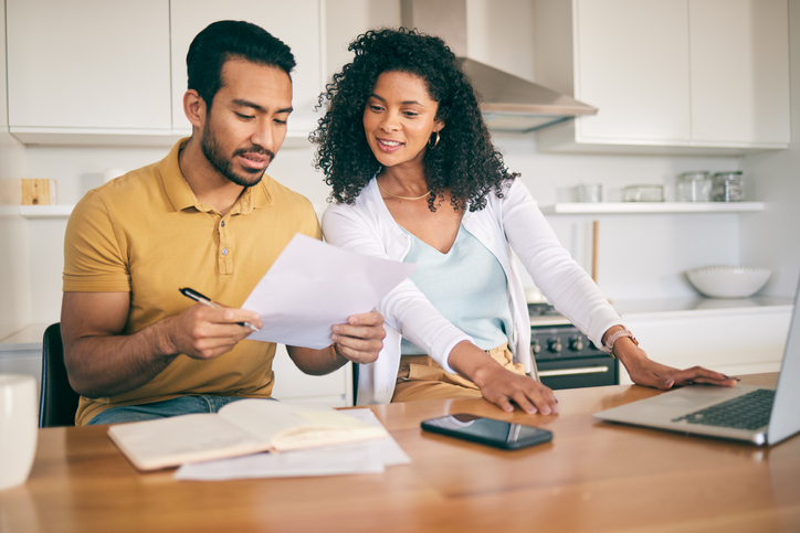 A couple figuring out their taxes based on a progressive tax system. 