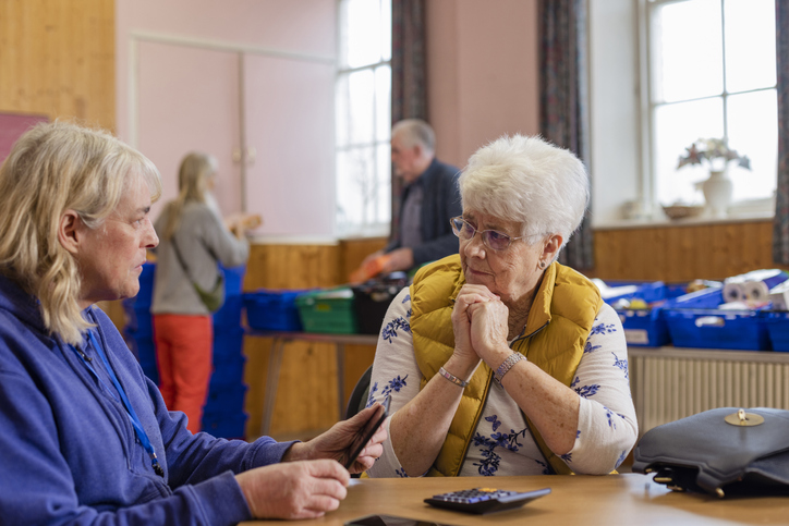 A senior calculating how much money to donate from her IRA.