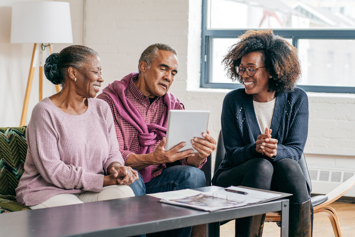 A senior couple meeting with a financial advisor to manage their charitable contributions.