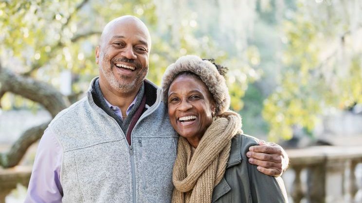 A couple that retired at age 60 enjoys a fall day together.