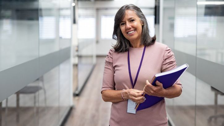 A teacher who's nearing retirement smiles after a meeting about her pension plan. 