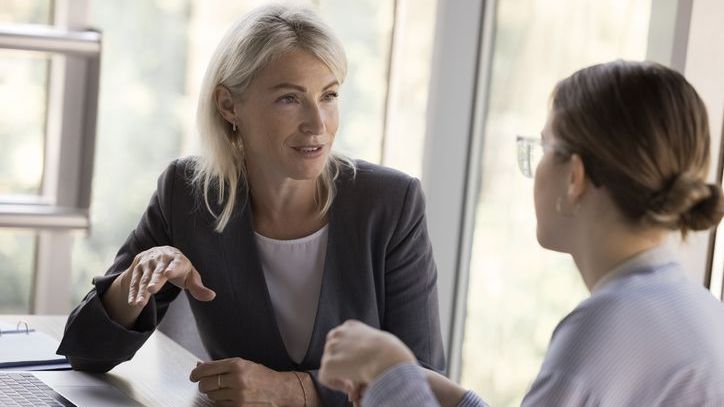 A financial advisor discusses retirement savings goals and progress with a young client.