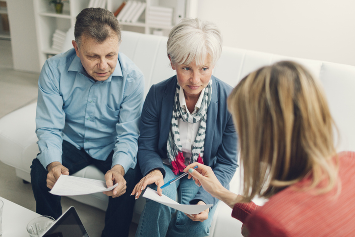 A senior couple meeting with a financial advisor to review their retirement plan.